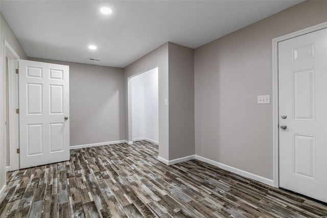 empty room with dark hardwood / wood-style flooring