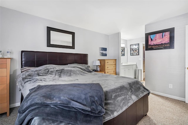 bedroom with light carpet and ensuite bath