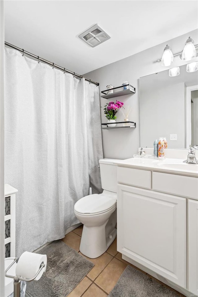 bathroom featuring curtained shower, vanity, toilet, and tile patterned floors