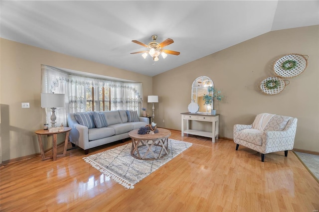 living room featuring lofted ceiling, light hardwood / wood-style floors, and ceiling fan