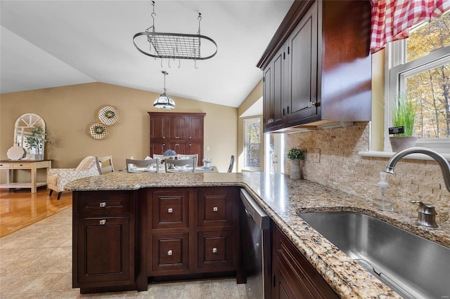 kitchen with stainless steel dishwasher, sink, light wood-type flooring, and a wealth of natural light