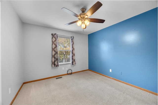 unfurnished room featuring ceiling fan and carpet floors