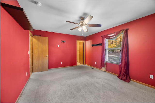 spare room with light carpet and ceiling fan