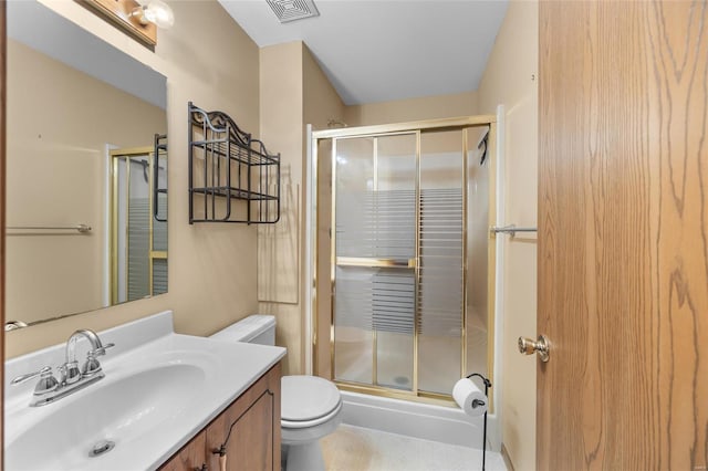 bathroom with vanity, toilet, and an enclosed shower