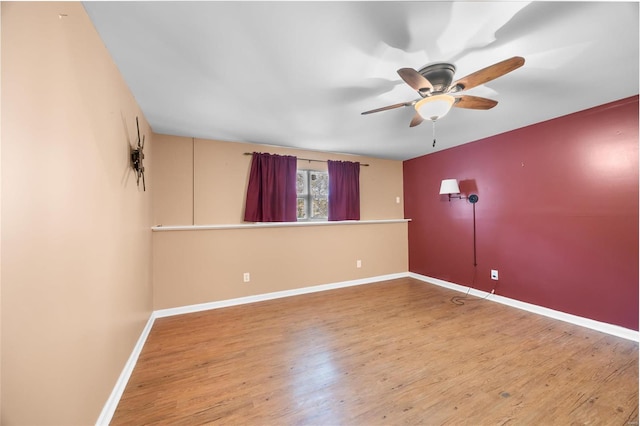 empty room featuring hardwood / wood-style flooring and ceiling fan