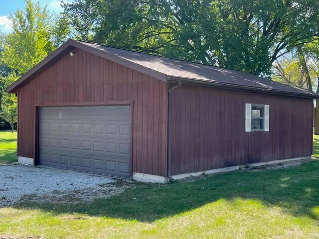 garage with wooden walls and a yard