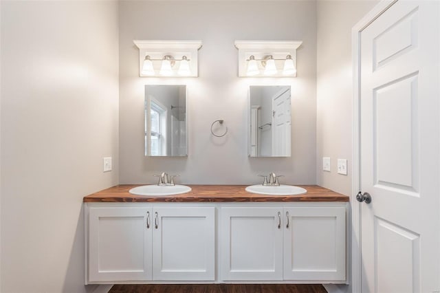 bathroom featuring a sink and double vanity