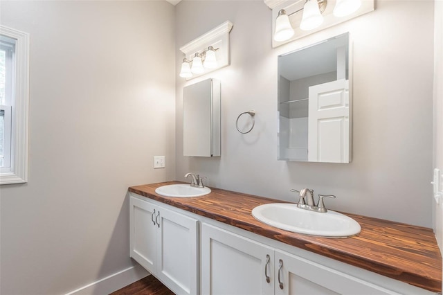 bathroom with a sink and double vanity