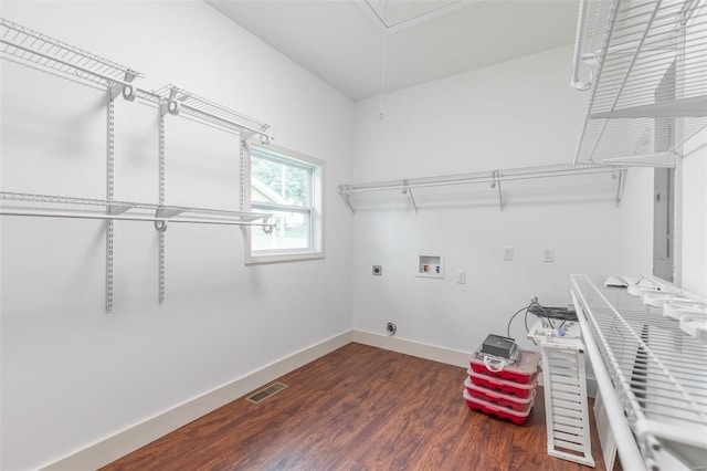 clothes washing area with laundry area, hookup for a washing machine, baseboards, hookup for an electric dryer, and visible vents
