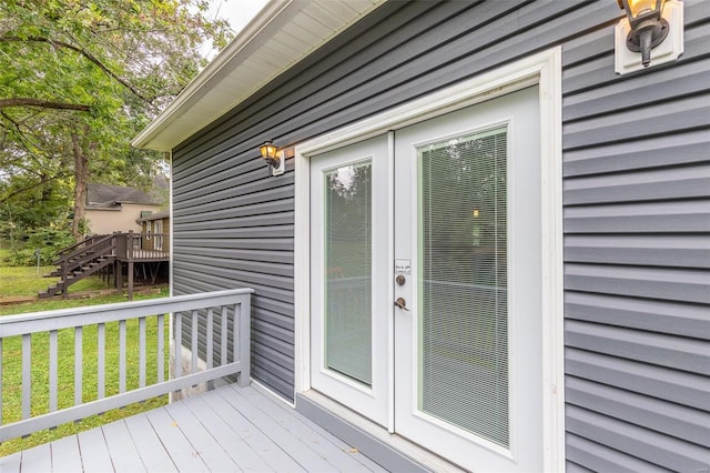 deck featuring a yard and stairway