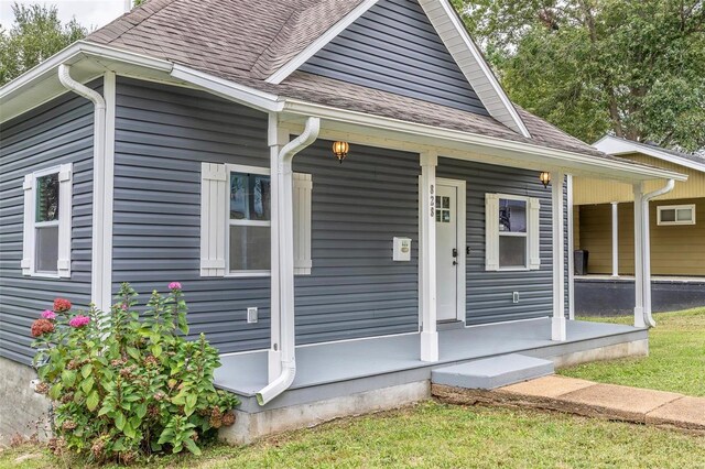 bungalow-style house featuring covered porch and roof with shingles