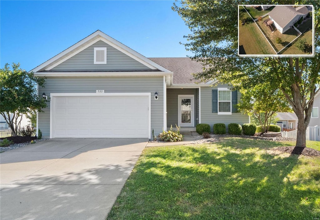 ranch-style home with a front yard and a garage