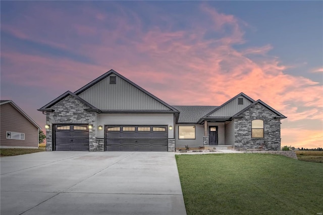 craftsman-style home with a lawn and a garage