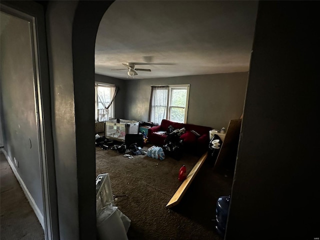 living room with ceiling fan and carpet flooring