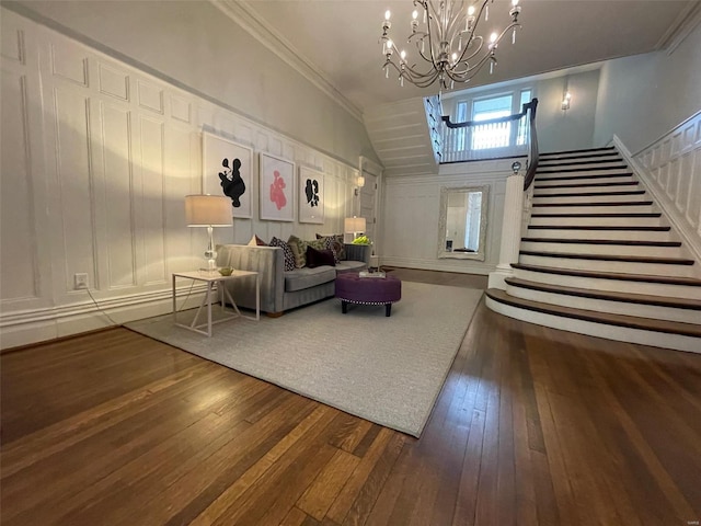 interior space featuring ornamental molding, an inviting chandelier, lofted ceiling, and dark hardwood / wood-style flooring