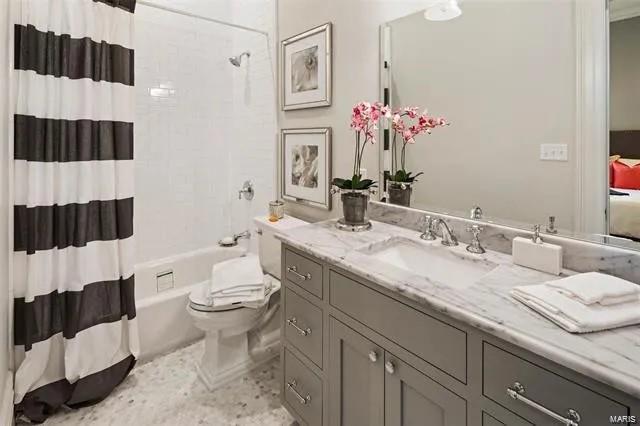 full bathroom featuring vanity, toilet, and shower / bath combination with curtain