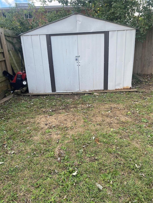 view of outbuilding featuring a yard