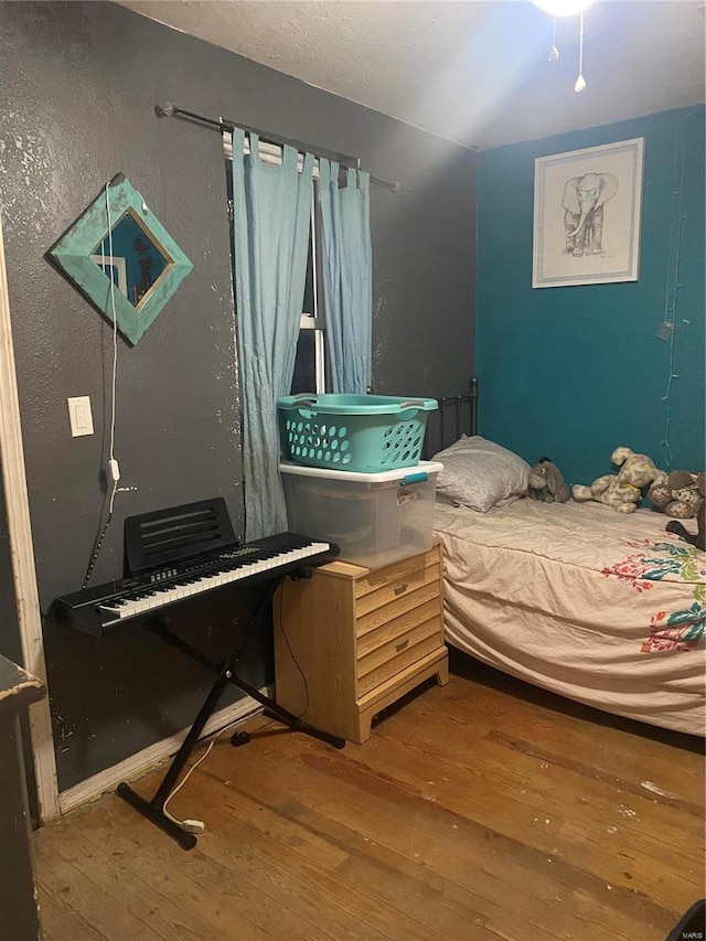 bedroom with wood-type flooring