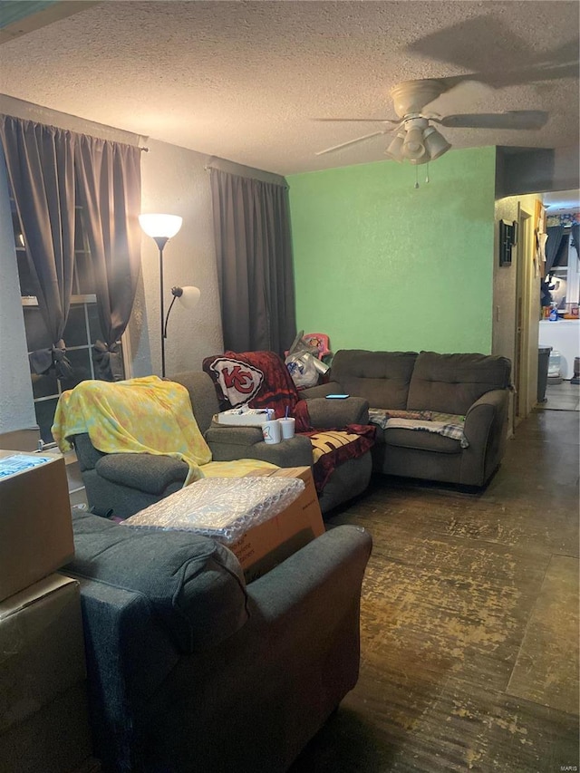 living room with ceiling fan and a textured ceiling