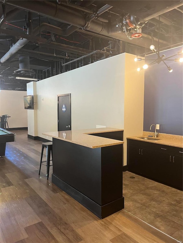 kitchen featuring wood-type flooring, sink, a kitchen island, a high ceiling, and billiards