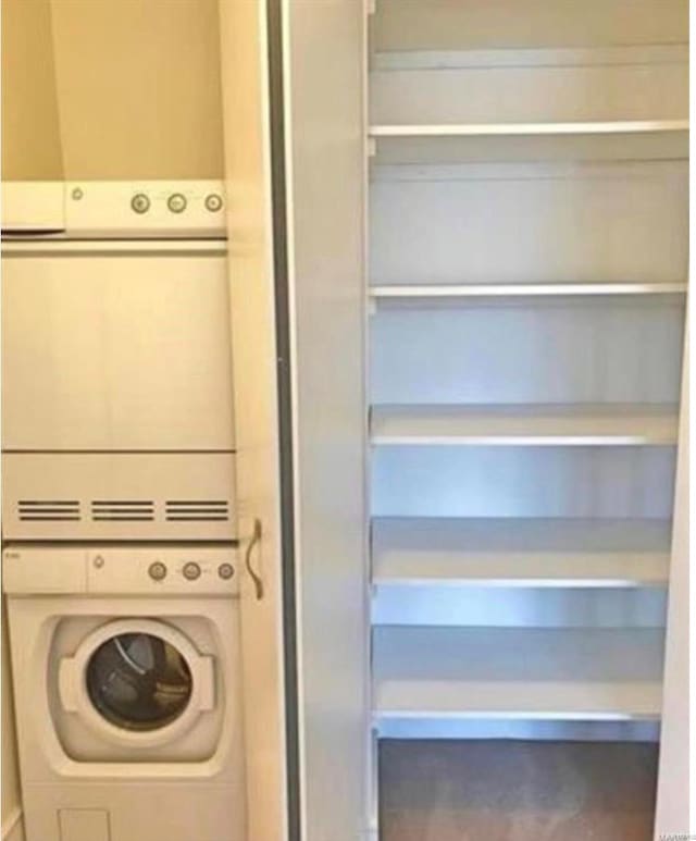 laundry room with stacked washer / dryer