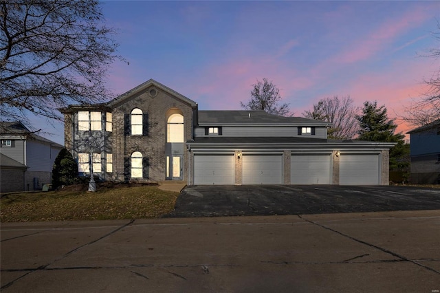 view of front of property with aphalt driveway and brick siding