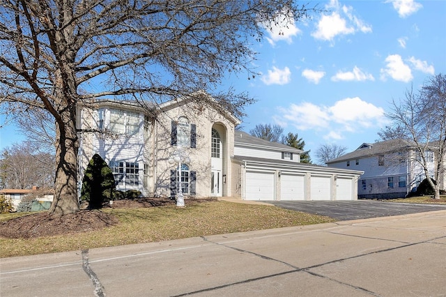 view of front of property featuring a garage and aphalt driveway