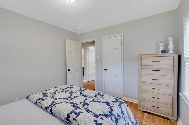 bedroom featuring light hardwood / wood-style flooring and multiple windows