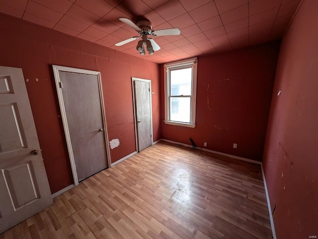 unfurnished bedroom with light hardwood / wood-style floors and ceiling fan