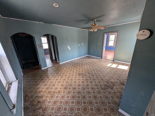 spare room featuring ceiling fan and ornamental molding