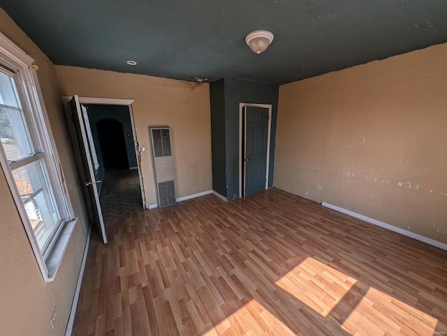 unfurnished bedroom featuring hardwood / wood-style flooring