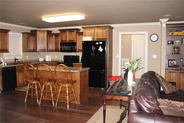 kitchen featuring black appliances, a kitchen bar, crown molding, and dark hardwood / wood-style flooring