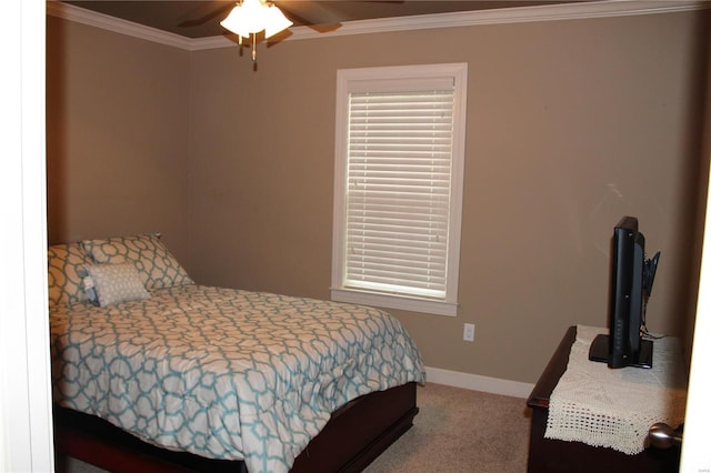 carpeted bedroom with ceiling fan and crown molding