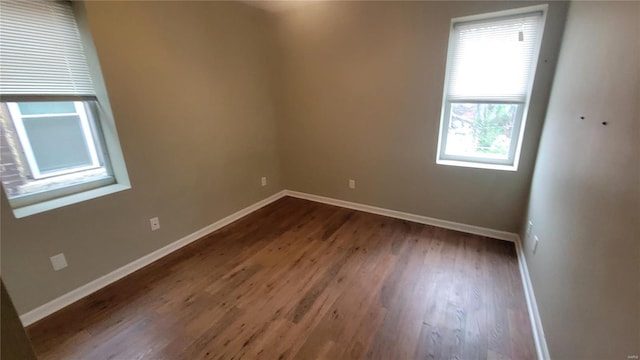 spare room with dark hardwood / wood-style flooring