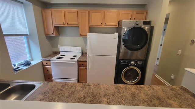 kitchen featuring stacked washer / dryer, sink, light brown cabinetry, and white appliances