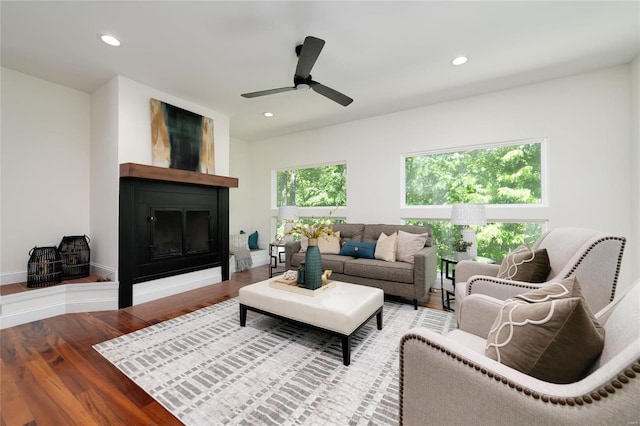 living room featuring ceiling fan and hardwood / wood-style flooring