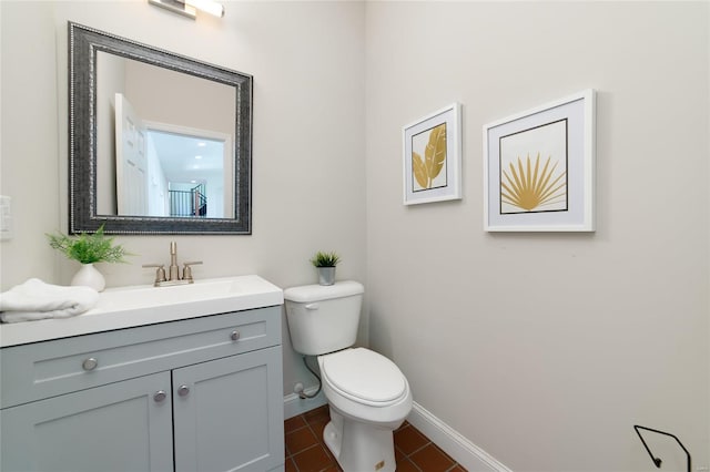 bathroom with tile patterned floors, vanity, and toilet