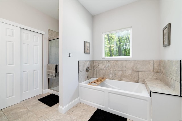 bathroom featuring shower with separate bathtub and tile patterned floors