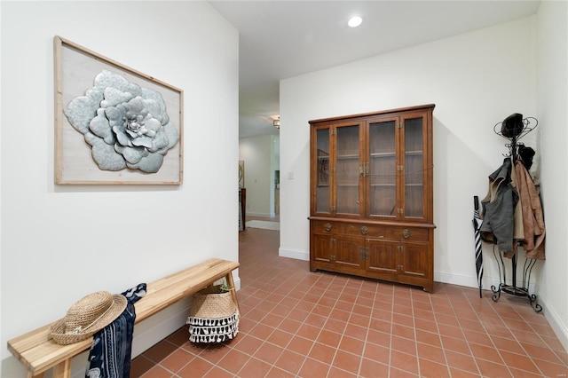 hall featuring light tile patterned floors