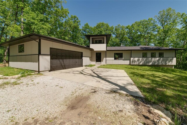 view of front facade with a front lawn and a garage