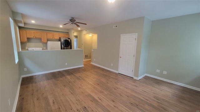 unfurnished living room featuring ceiling fan and light wood-type flooring