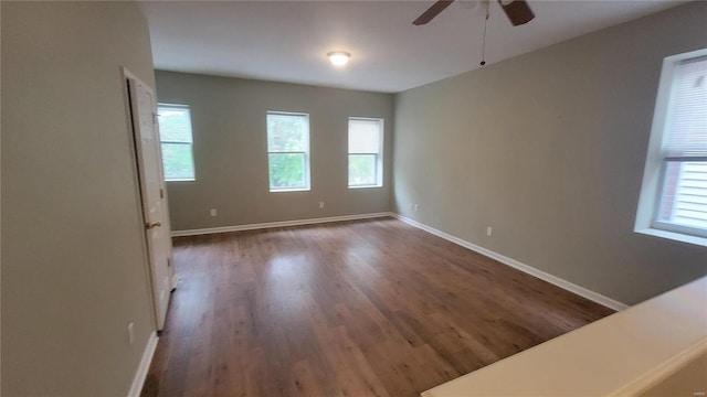 spare room with dark hardwood / wood-style floors and ceiling fan