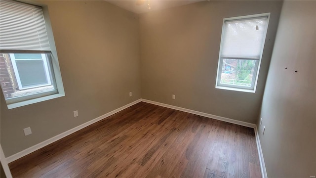 empty room with dark hardwood / wood-style floors