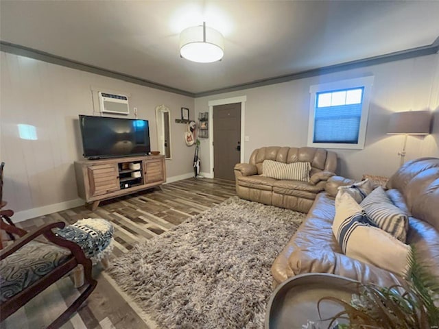 living room featuring ornamental molding, dark hardwood / wood-style flooring, and a wall mounted AC