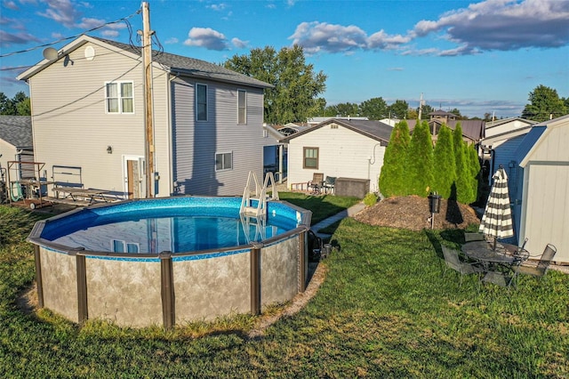 view of swimming pool featuring a shed and a lawn