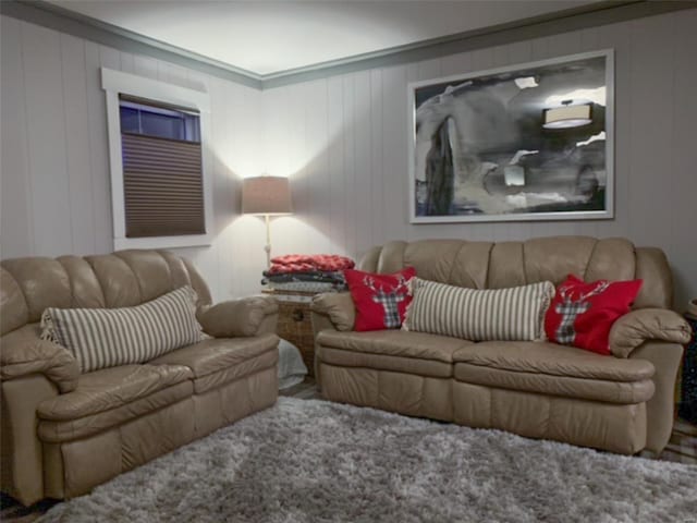 living room with wooden walls and crown molding