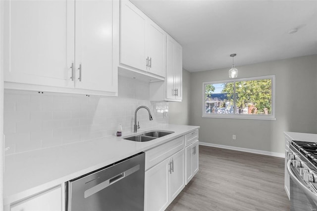 kitchen featuring light hardwood / wood-style flooring, white cabinets, appliances with stainless steel finishes, and sink