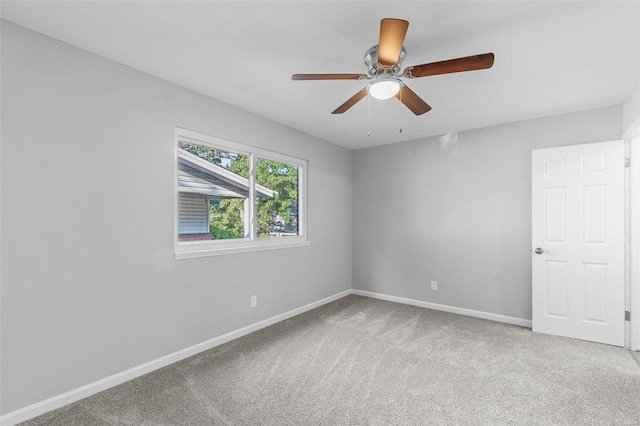 carpeted empty room featuring ceiling fan