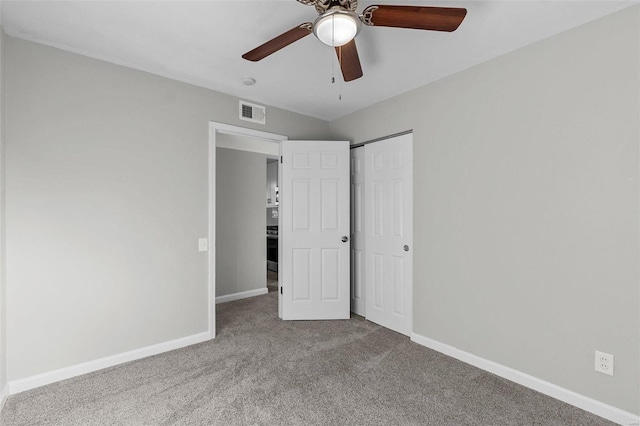 unfurnished bedroom featuring carpet flooring, ceiling fan, and a closet