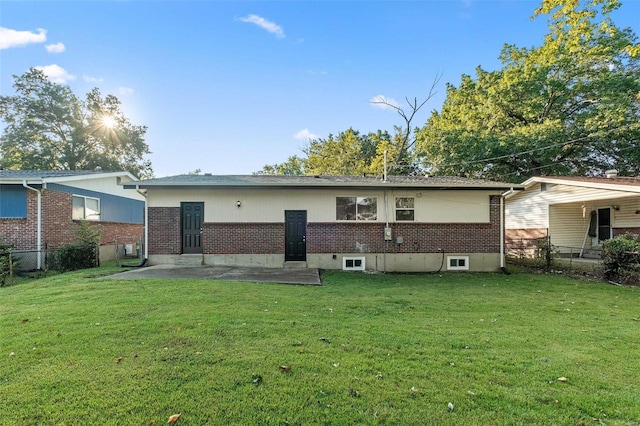 rear view of property with a yard and a patio